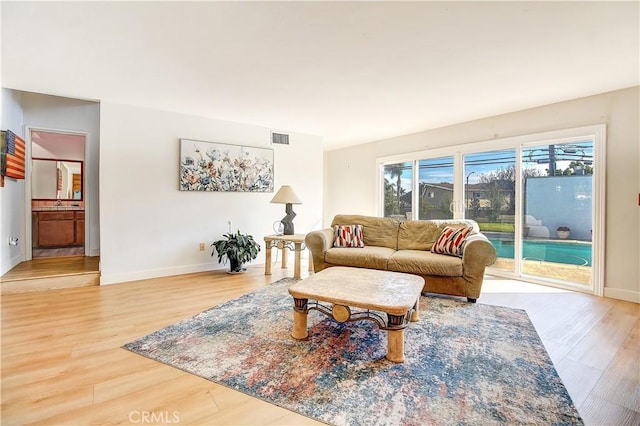 living room with hardwood / wood-style flooring and sink