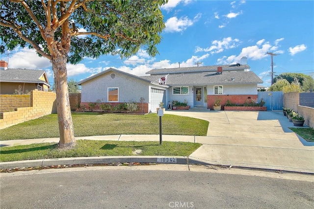 ranch-style house featuring a garage and a front lawn