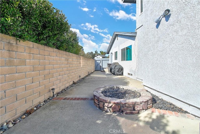 exterior space featuring a patio and an outdoor fire pit