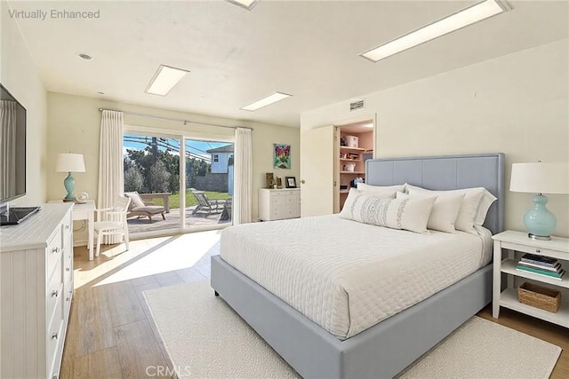 bedroom featuring light wood-type flooring and access to outside