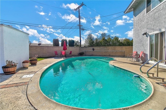 view of swimming pool with a patio