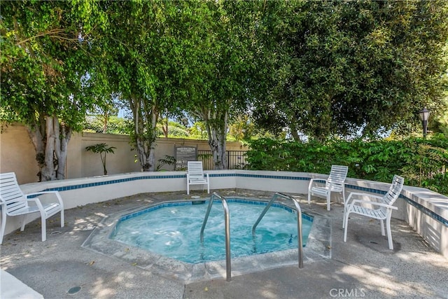 view of swimming pool with a patio area, an in ground hot tub, and fence private yard