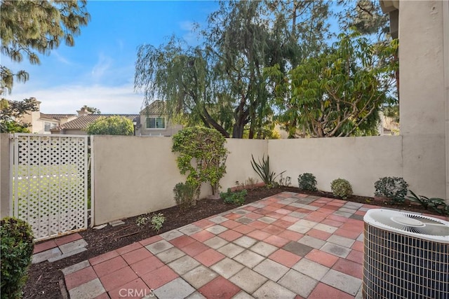 view of patio featuring central AC unit and a fenced backyard