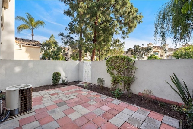 view of patio with central AC unit and a fenced backyard