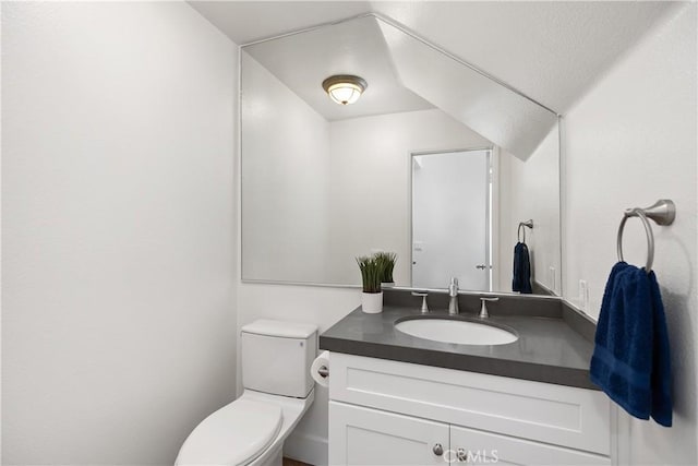 bathroom with toilet and vanity