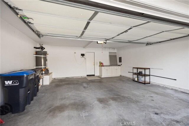 garage with secured water heater and a garage door opener