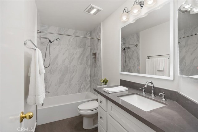 bathroom featuring vanity, shower / bathing tub combination, toilet, and visible vents