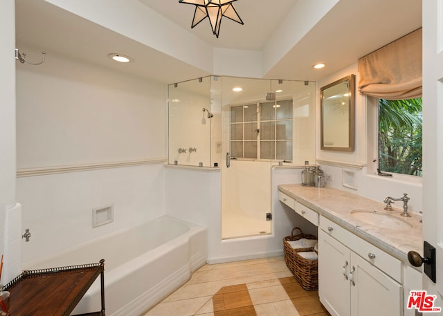 bathroom with shower with separate bathtub, tile patterned floors, and vanity