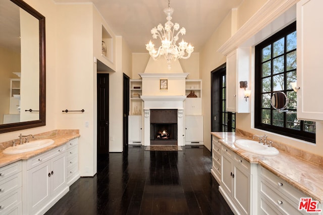 bathroom with vanity, a fireplace, and wood-type flooring