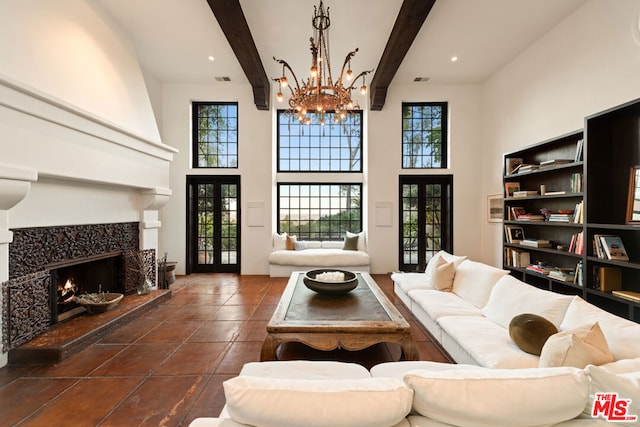 living room featuring a tiled fireplace, a high ceiling, french doors, and beamed ceiling