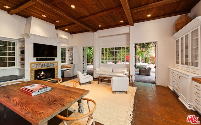 living room featuring beamed ceiling, a high ceiling, and wooden ceiling