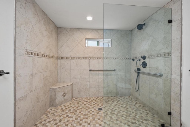 bathroom with a shower with door