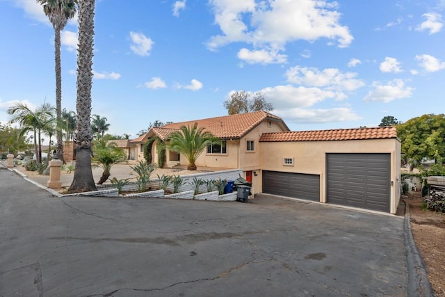 mediterranean / spanish-style home with a garage