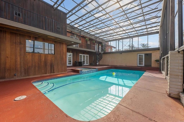 view of pool featuring an in ground hot tub and a lanai