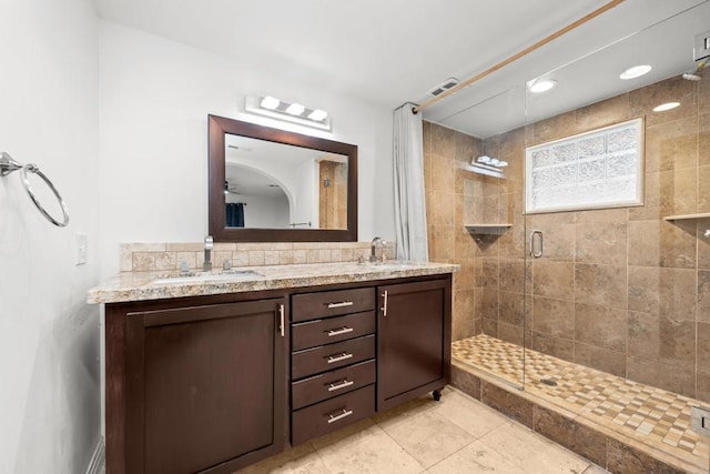 bathroom with walk in shower and vanity