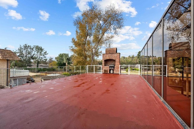 view of patio / terrace with a fireplace and grilling area