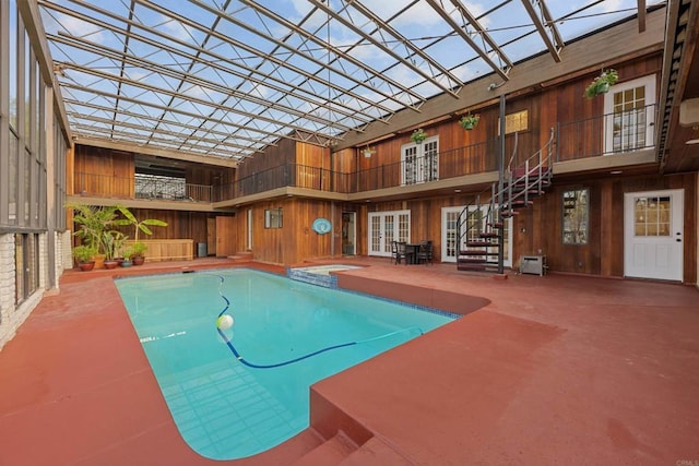 view of pool featuring an in ground hot tub, a patio area, a lanai, and french doors