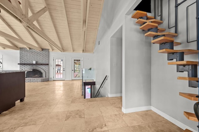 staircase featuring a fireplace, wooden ceiling, and lofted ceiling with beams