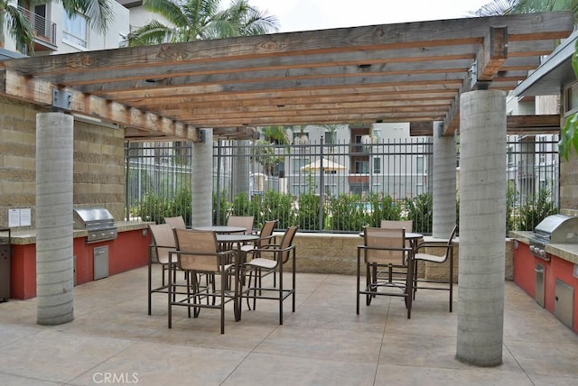 view of patio / terrace with exterior kitchen, exterior bar, area for grilling, and a pergola