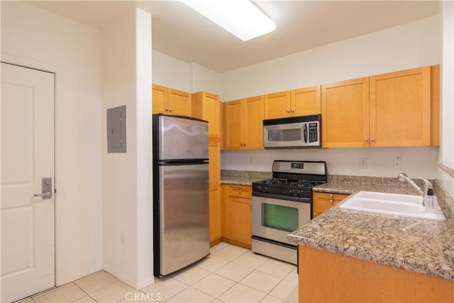 kitchen featuring light brown cabinetry, appliances with stainless steel finishes, sink, electric panel, and light tile patterned floors