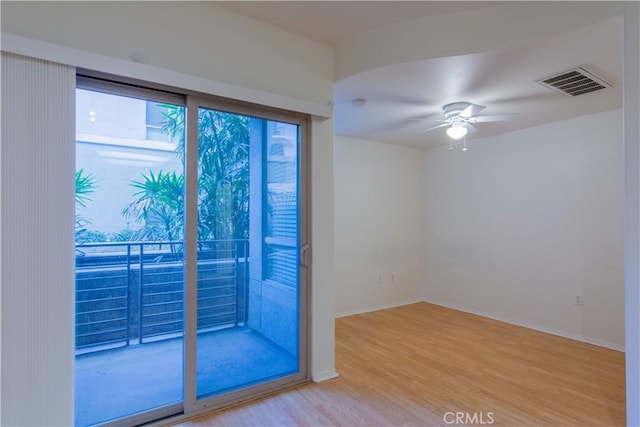 empty room with light wood-type flooring and ceiling fan