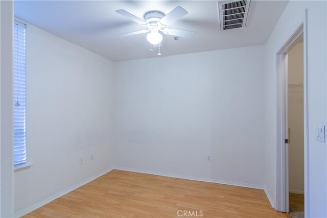 spare room featuring ceiling fan and light hardwood / wood-style flooring