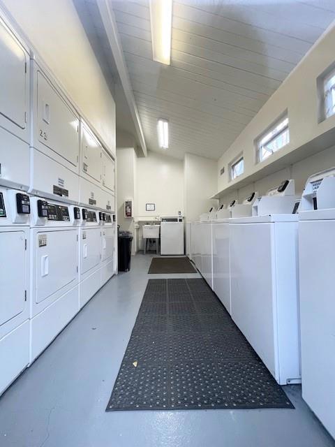 washroom featuring washing machine and dryer and stacked washer / drying machine