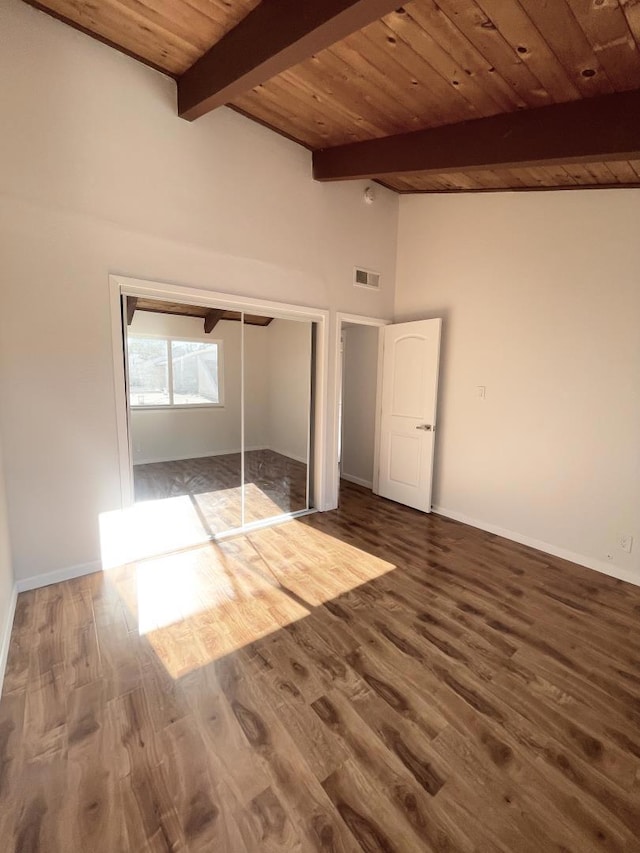 unfurnished bedroom with wood ceiling, beam ceiling, hardwood / wood-style floors, and a closet