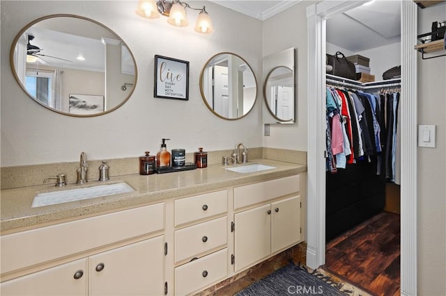 bathroom with vanity, ceiling fan, and ornamental molding