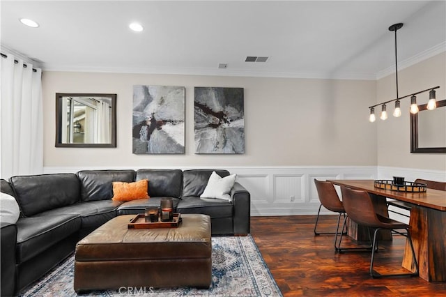 living room featuring dark hardwood / wood-style flooring and ornamental molding