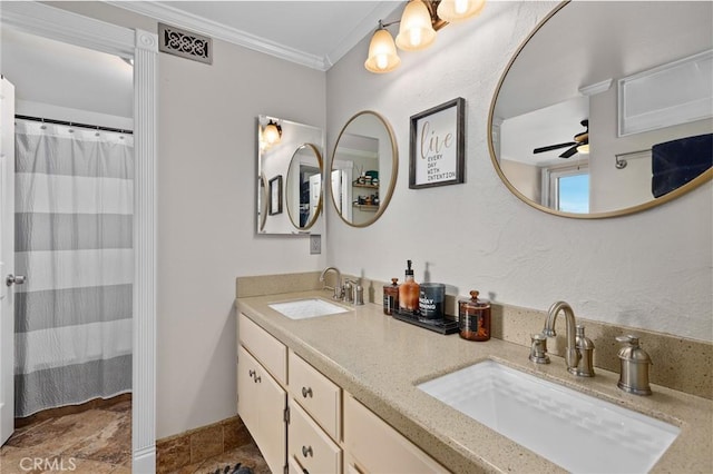 bathroom with crown molding, ceiling fan, and vanity