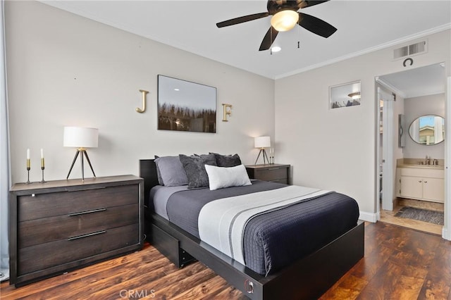 bedroom with ceiling fan, connected bathroom, crown molding, and dark wood-type flooring