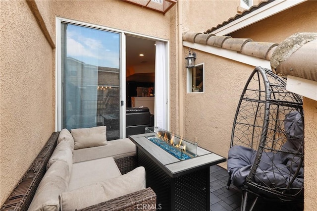 view of patio / terrace with an outdoor living space with a fire pit