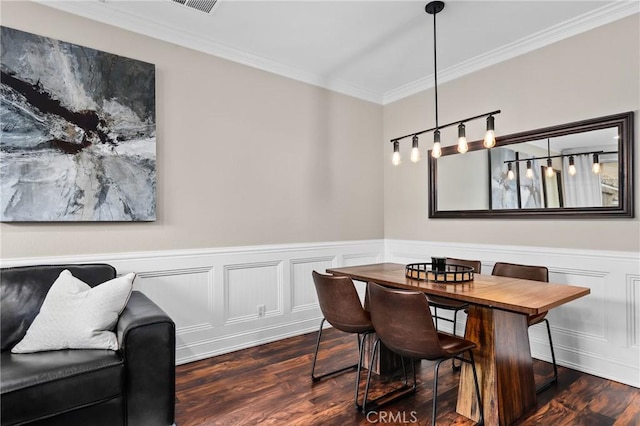 dining room with crown molding and dark hardwood / wood-style flooring