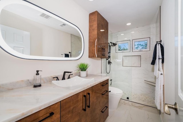 bathroom featuring toilet, a shower with shower door, and vanity