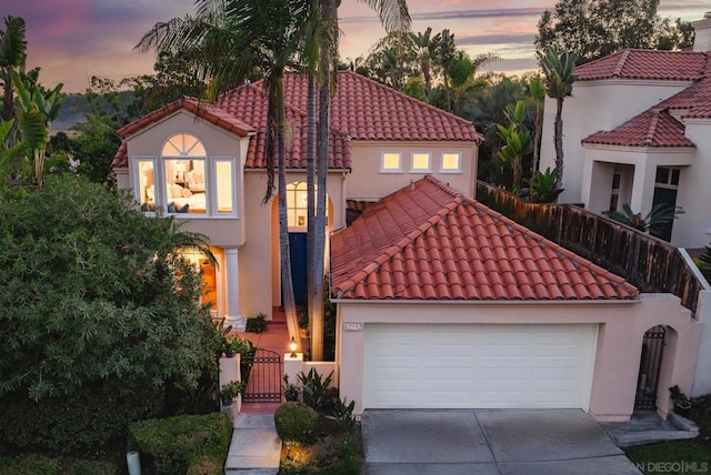 mediterranean / spanish-style home with a garage