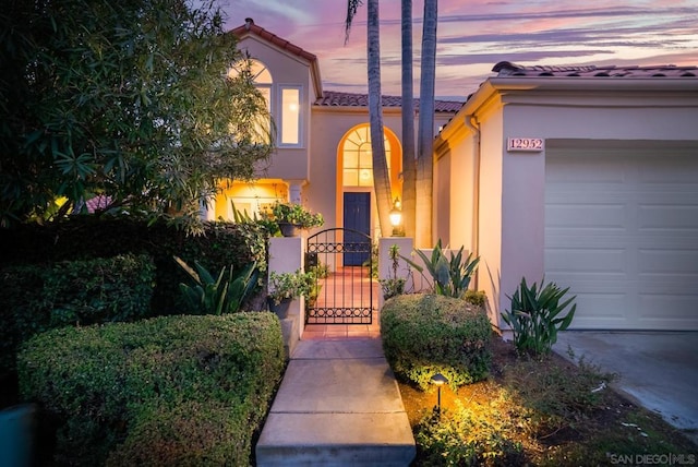 mediterranean / spanish-style home with a garage