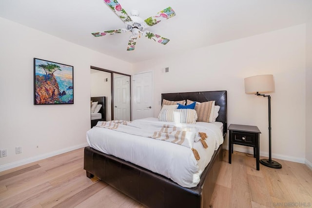 bedroom featuring light hardwood / wood-style floors, a closet, and ceiling fan