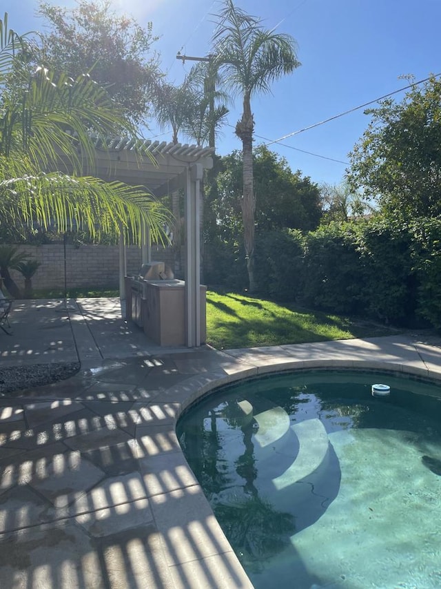 view of swimming pool featuring a pergola and a patio area