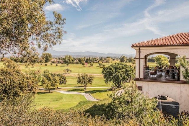 view of property's community with a yard and a mountain view