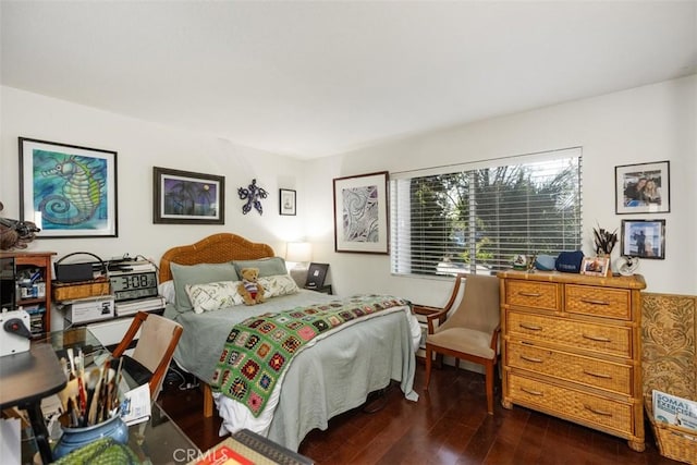 bedroom with dark wood-type flooring