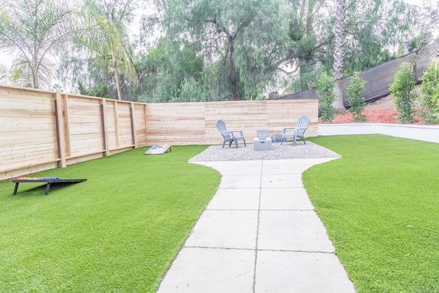 view of yard featuring a fire pit and a patio