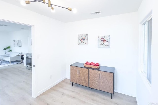 hallway with light hardwood / wood-style flooring