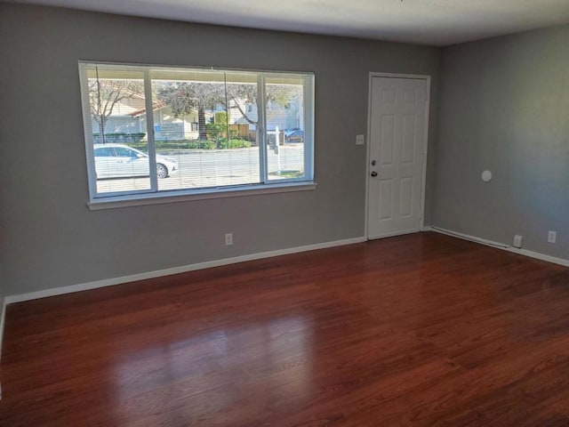 spare room featuring dark wood-type flooring