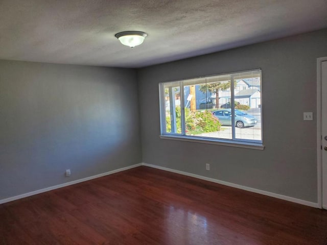 spare room with dark hardwood / wood-style floors