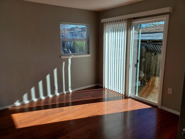 unfurnished room with hardwood / wood-style floors