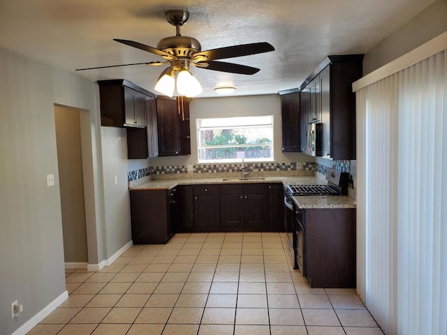 kitchen with sink, backsplash, stainless steel appliances, and light tile patterned flooring