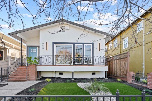 rear view of property featuring a yard