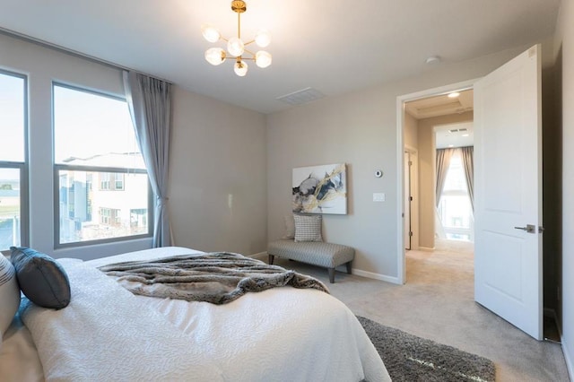 carpeted bedroom featuring an inviting chandelier