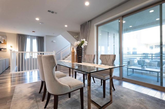 dining space with hardwood / wood-style flooring